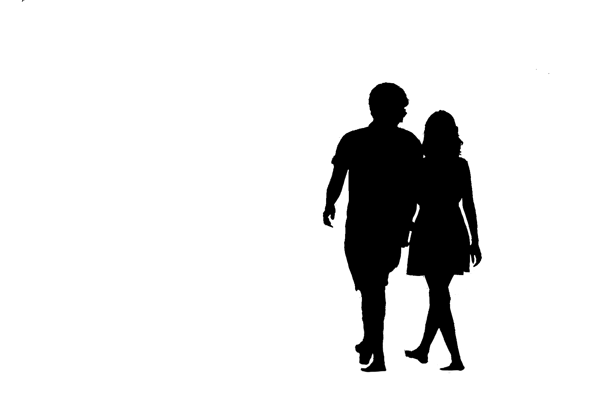 silhouette of a guy and girl holding hands while walking
