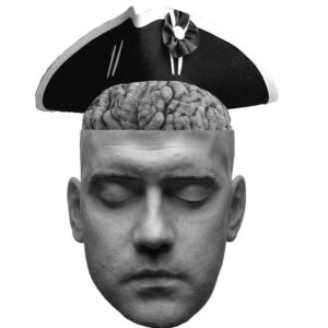 A head having its brain replaced with another wearing a Revolutionary War hat 