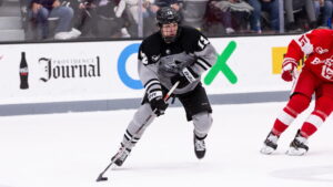 Jack Dugan pushes the puck again Boston University