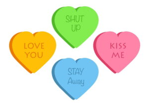 Candy hearts with sayings on them that say, "Love You," "Kiss Me," "Shut Up," and "Stay Away."