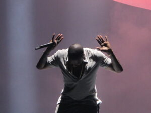Kanye West hands raised in concert