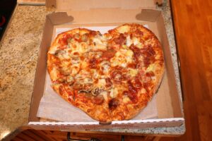 Heart-shaped pizza in a box
