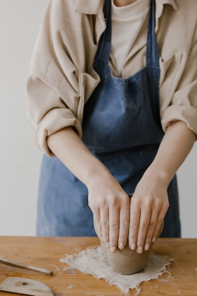 woman sculpting clay