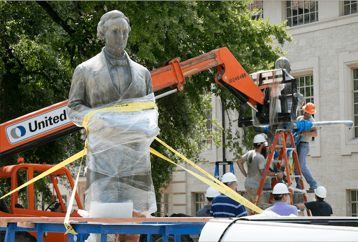 Three men removing the Jefferson Davis statue from UT-Austin's campus.