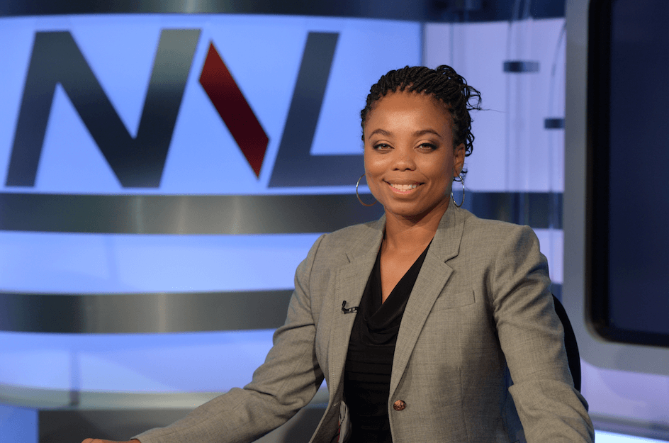 ESPN journalist, Jemele Hill., sitting at a desk