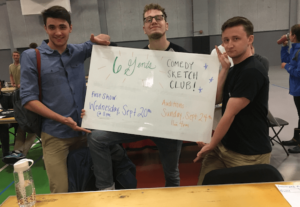 Three six gents members hold up a sign at the Providence College involvement fair.