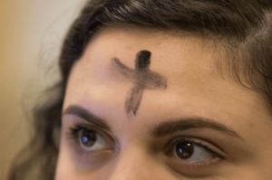 Ashes on a girl's forehead for Ash Wednesday