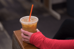 A hand holding a coffee