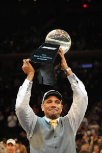 Coach Ed Cooley holding trophy