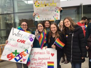 PC students holding signs in support of the LGBTQ+ community