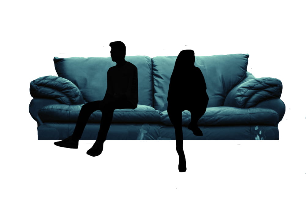 A silhouette of a man and a woman sitting awkwardly on a couch