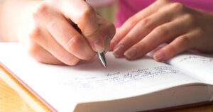 person writing in a diary