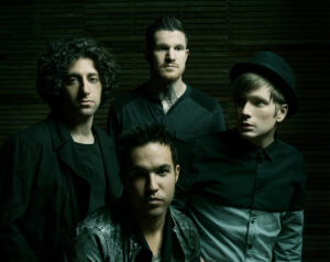 Fall Out Boy band members posing for a photoshoot for new album, M A N I A.