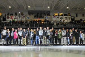 PC's Men Ice Hockey's four senior pose together with their families on the ice before the game versus Maine.
