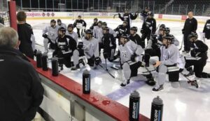 Providence College hockey team kneels during practice in Ireland