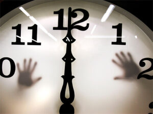 Clock at midnight with hands trapped behind it