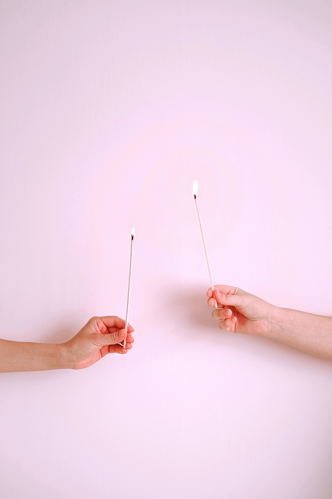 hands holding one match each