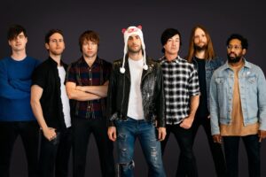 Maroon 5, from left to right TK. Adam Levine is in the center with a hat on.