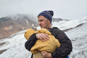 Phil Elverum of Mount Eerie and the Microphones carries his daughter.
