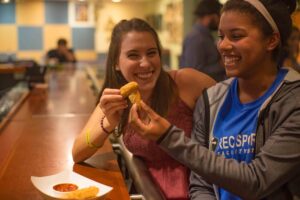 a photo of two girls eating mozzarella sticks in McPhail's