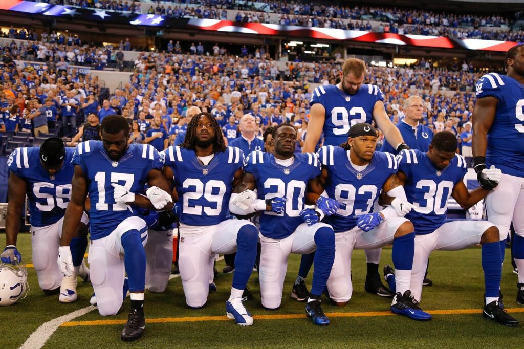 NFL players taking a knee during the national anthem.