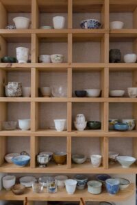 cups lined up on a shelf 