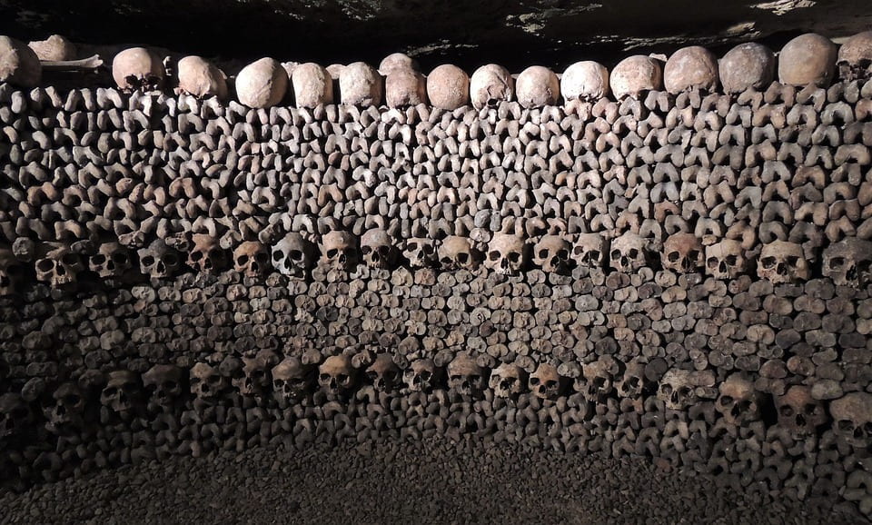 Skulls stacked upon each other to form a wall of skulls