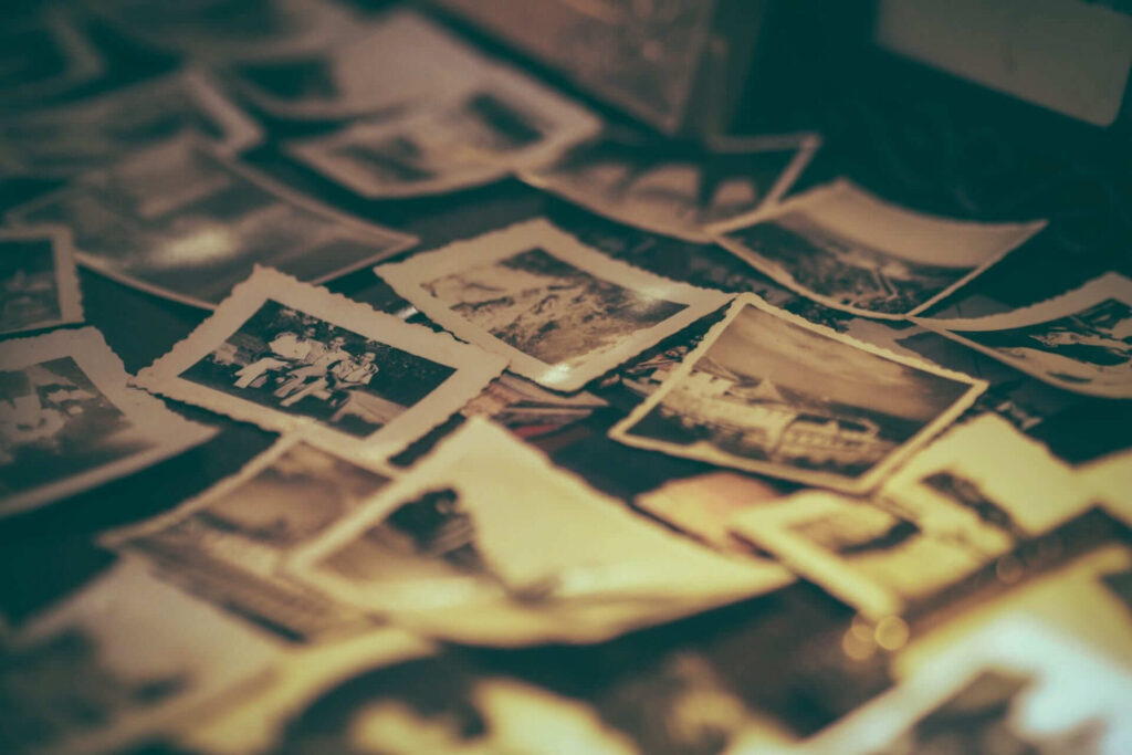 A bunch of old photographs in a pile