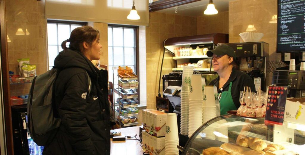 Photo of a student ordering from the Starbucks in the Ruane Center for the Humanities.