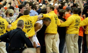 Security holds back fans from running onto the court.