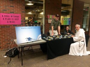 Friar and students write goals down