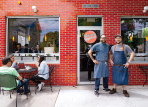 Chef Jake Rojas and chef de cuisine Ben Cantone stand outside Talluah's Taqueria in Providence.