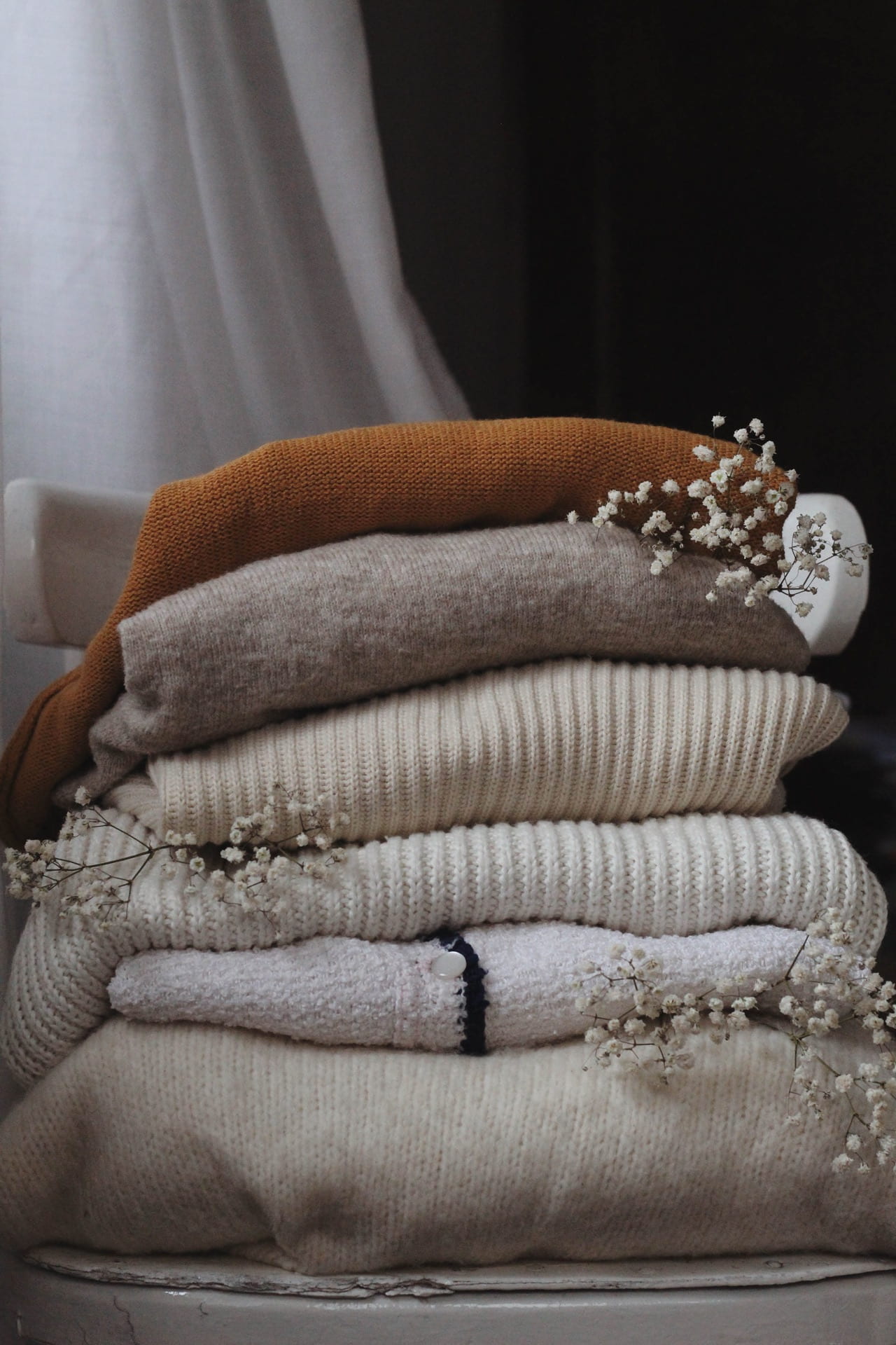 a stack of folded sweaters